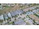 Overhead shot of residential area featuring modern townhouses, manicured lawns, and orderly street parking at 1614 Moon Valley Dr, Davenport, FL 33896