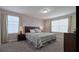 Comfortable bedroom with neutral walls, large windows, and two nightstands with lamps at 1614 Moon Valley Dr, Davenport, FL 33896