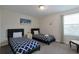 Comfortable bedroom with matching twin beds, neutral walls, and window views at 1614 Moon Valley Dr, Davenport, FL 33896