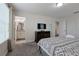 Bedroom featuring ensuite bathroom, tv, and patterned bedspread at 1614 Moon Valley Dr, Davenport, FL 33896