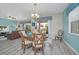 Light-filled dining area with stylish furnishings, including a chandelier and seating for four at 1614 Moon Valley Dr, Davenport, FL 33896