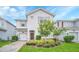 Charming two-story home with a well-manicured lawn and colorful landscaping at 1614 Moon Valley Dr, Davenport, FL 33896