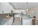 Spacious kitchen featuring white cabinetry, stainless steel appliances, and a granite island with seating at 1614 Moon Valley Dr, Davenport, FL 33896