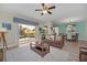 Cozy living room featuring a sliding glass door, leather sofa, and modern rug at 1614 Moon Valley Dr, Davenport, FL 33896