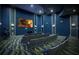 Home theater featuring comfortable seating, large screen, and stylish design for an immersive viewing experience at 1614 Moon Valley Dr, Davenport, FL 33896