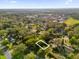 Aerial view of land plot surrounded by trees in a residential area at 1620 N Rhodes St, Mount Dora, FL 32757