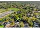 An aerial view of land plot surrounded by trees in a neighborhood with nearby tennis courts, park, and greenery at 1620 N Rhodes St, Mount Dora, FL 32757