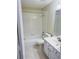 Bright bathroom featuring a tub/shower combo, white tile, and a vanity at 1661 Stafford Springs Blvd, Mount Dora, FL 32757