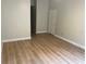 Bedroom featuring wood-look floors, neutral walls, and a doorway at 1661 Stafford Springs Blvd, Mount Dora, FL 32757