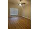 Bedroom with wood-look floors, a ceiling fan, and a window with blinds at 1661 Stafford Springs Blvd, Mount Dora, FL 32757