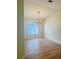 Bright dining room with modern chandelier and hardwood floors overlooking the backyard at 1661 Stafford Springs Blvd, Mount Dora, FL 32757