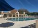 Community pool featuring lounge seating and shade under the blue sky at 1661 Stafford Springs Blvd, Mount Dora, FL 32757