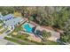 An aerial view of the community pool and surrounding landscape, highlighting nearby homes and trees at 16628 Citrus Pkwy, Clermont, FL 34714