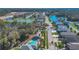 Expansive aerial view of community with a pool, lush landscaping, and serene lakes at 16628 Citrus Pkwy, Clermont, FL 34714