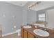 Bright bathroom with a tub and shower combination, complemented by a double sink vanity at 16628 Citrus Pkwy, Clermont, FL 34714