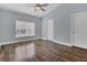 Spacious bedroom featuring a ceiling fan, modern window blinds, and stylish wood-look flooring at 16628 Citrus Pkwy, Clermont, FL 34714