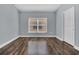 Bright bedroom featuring a modern window, and stylish wood-look flooring at 16628 Citrus Pkwy, Clermont, FL 34714