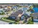 Angle eye-level view of a cozy single-Gathering home with a manicured lawn, palm trees, and blue skies at 16628 Citrus Pkwy, Clermont, FL 34714