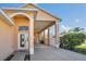 Inviting front entrance with arched doorway and porte-cochere providing covered parking and shelter from the elements at 16628 Citrus Pkwy, Clermont, FL 34714