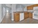 Spacious kitchen area featuring tile floors, oak cabinets, and white appliances at 16628 Citrus Pkwy, Clermont, FL 34714