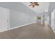 Bright living room featuring tile floors, modern ceiling fan and entry doorway at 16628 Citrus Pkwy, Clermont, FL 34714