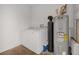 A well-equipped utility room with a washing machine, dryer, and water heater at 16628 Citrus Pkwy, Clermont, FL 34714