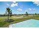 View of the backyard overlooking the community golf course from the outdoor patio at 17051 Se 115Th Terrace Rd, Summerfield, FL 34491