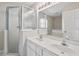 Modern bathroom featuring a double sink vanity and glass-enclosed shower at 17051 Se 115Th Terrace Rd, Summerfield, FL 34491