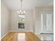 Bright dining room featuring wood floors, modern lighting, and a large window at 17051 Se 115Th Terrace Rd, Summerfield, FL 34491