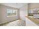 Cozy kitchen area with a large window offering natural light and neighborhood views at 17051 Se 115Th Terrace Rd, Summerfield, FL 34491