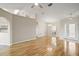 Inviting living room featuring archway, hardwood floors, and view of kitchen and front entryway at 17051 Se 115Th Terrace Rd, Summerfield, FL 34491