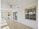 Relaxing sunroom with a ceiling fan and sliding glass doors leading to the backyard at 17051 Se 115Th Terrace Rd, Summerfield, FL 34491