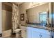 Bathroom featuring granite countertops, a large mirror, and a shower-tub combo at 17108 Se 111Th Terrace Rd, Summerfield, FL 34491