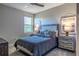 Bedroom features carpet floors, a bed, nightstands, and a ceiling fan at 17108 Se 111Th Terrace Rd, Summerfield, FL 34491