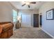 Bedroom with carpet flooring, ceiling fan, and double door closet at 17108 Se 111Th Terrace Rd, Summerfield, FL 34491