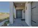 Welcoming front entry with a covered porch and elegant gray brick walkway at 17108 Se 111Th Terrace Rd, Summerfield, FL 34491