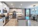 Spacious kitchen featuring stainless steel appliances, granite countertops, white cabinets, and a center island at 17108 Se 111Th Terrace Rd, Summerfield, FL 34491