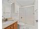 Bathroom features a vanity with granite counters and tiled shower enclosure at 1713 El Nino St, The Villages, FL 32162