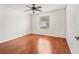 Sunlit bedroom with wood floors, a neutral color palette, and ample closet space at 1713 El Nino St, The Villages, FL 32162