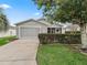 Charming single-story home with a well-maintained lawn and a screened garage in a desirable neighborhood at 1713 El Nino St, The Villages, FL 32162