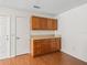 Functional eat-in kitchen area with wood cabinets and granite countertops at 1713 El Nino St, The Villages, FL 32162