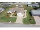 Aerial view of a well-kept home with a two-car garage, neat landscaping, and a long driveway at 17937 Se 107Th Ter, Summerfield, FL 34491