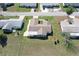 Birds eye view of a well maintained home featuring a two-car garage, mature trees, and manicured lawn at 17937 Se 107Th Ter, Summerfield, FL 34491