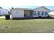 This is a view of a backyard with green grass and mature landscaping at 17937 Se 107Th Ter, Summerfield, FL 34491