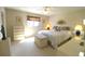 Comfortable bedroom featuring a ceiling fan, large window, and plush carpet at 17937 Se 107Th Ter, Summerfield, FL 34491