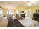 Bright living room featuring vaulted ceilings, a fireplace, and a ceiling fan at 17937 Se 107Th Ter, Summerfield, FL 34491