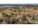 Lush aerial perspective featuring the home's position in a green, lakeside community at 1801 Summit Oaks Cir, Minneola, FL 34715