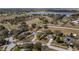 Wide aerial view showcases the property lines and the home's setting near green spaces and a serene lake at 1801 Summit Oaks Cir, Minneola, FL 34715