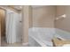 Bright bathroom featuring a soaking tub and a separate shower at 1801 Summit Oaks Cir, Minneola, FL 34715