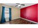 Sunny bedroom with ceiling fan, laminate floors, and a large window at 1801 Summit Oaks Cir, Minneola, FL 34715